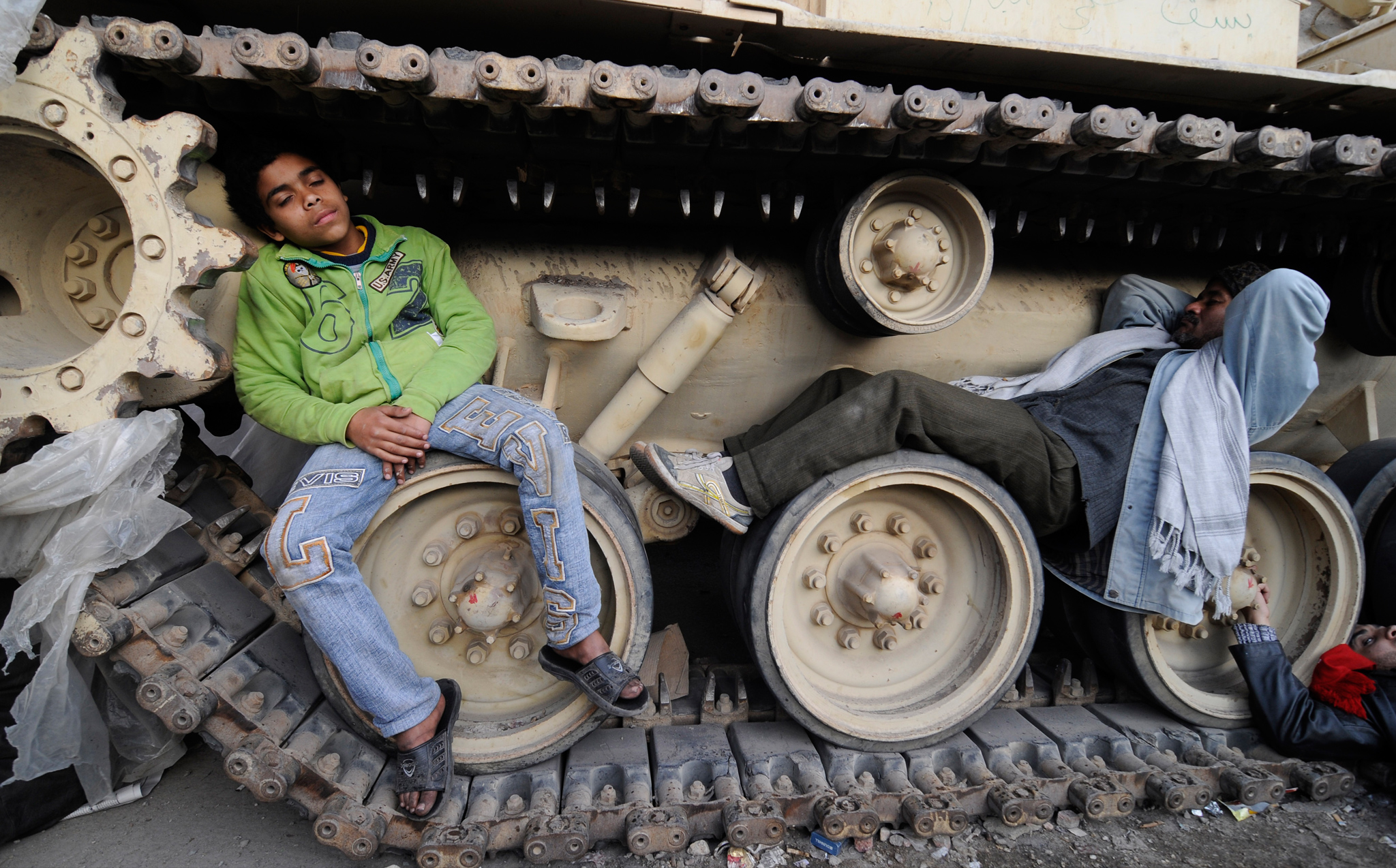 Some protesters, preparing for a prolonged occupation of Tahrir Square, caught up during their sleep <br>
on tanks stationed near the Museum of Cairo. (Photo credit: Mehdi Chebil)
